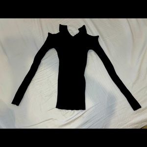 Black form fitting sweater with exposed shoulders